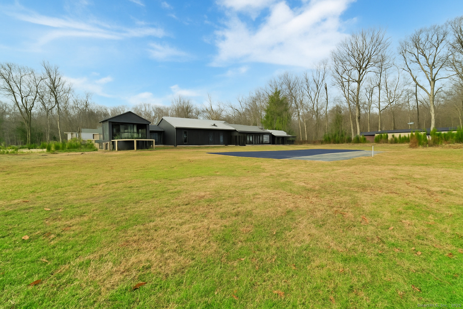 113 Woodbrook Drive Stamford, CT 06907 - Photo 35 of 39 a view of a large pool with an outdoor space and seating area