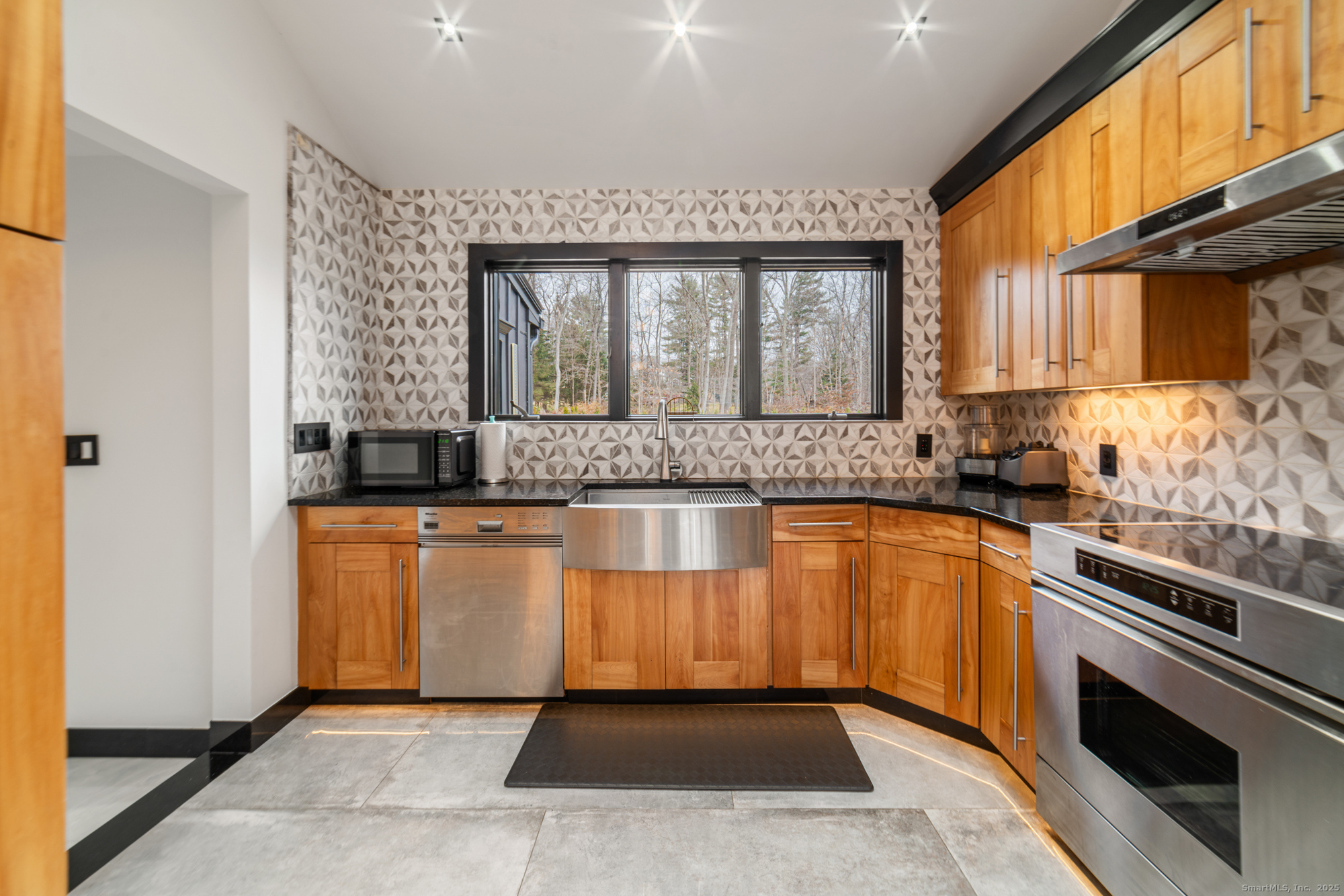 113 Woodbrook Drive Stamford, CT 06907 - Photo 8 of 39 a kitchen with stainless steel appliances granite countertop a stove a sink and a microwave