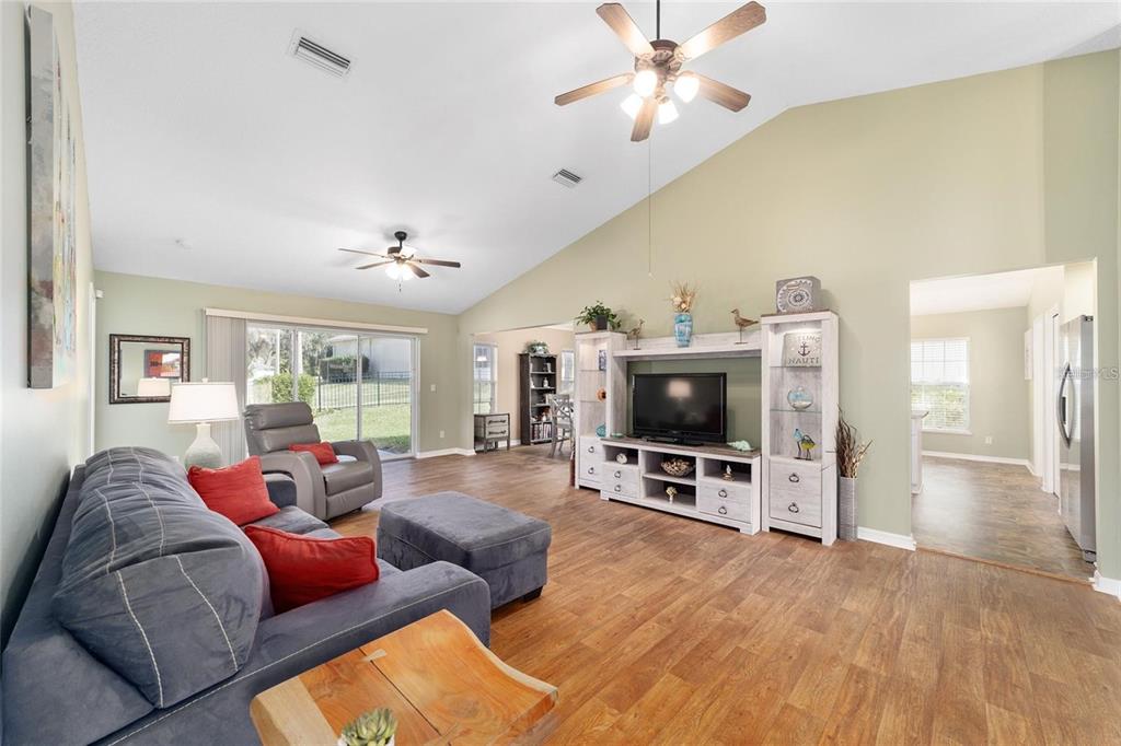 2656 Southwest 20th Circle Ocala, FL 34471 - Photo 2 of 6 a living room with furniture and a flat screen tv