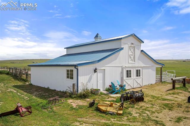 View of outbuilding featuring a rural view