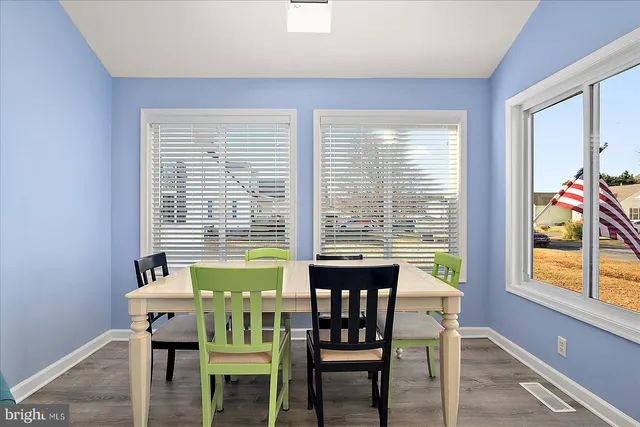 a view of a dining room with furniture and a window