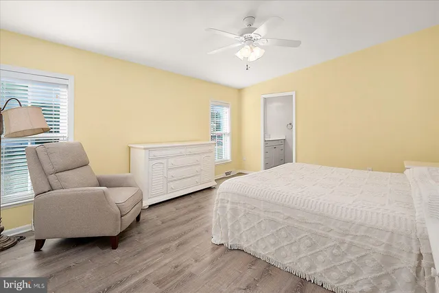 a bedroom with a bed a couch and dresser