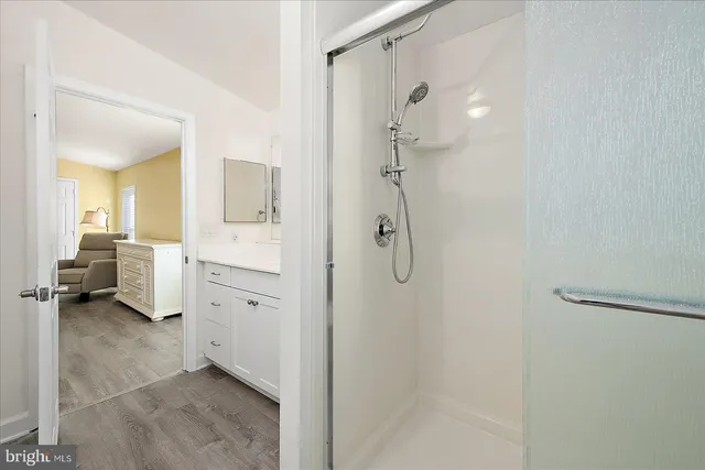 a spacious bedroom with a bed and a cabinets