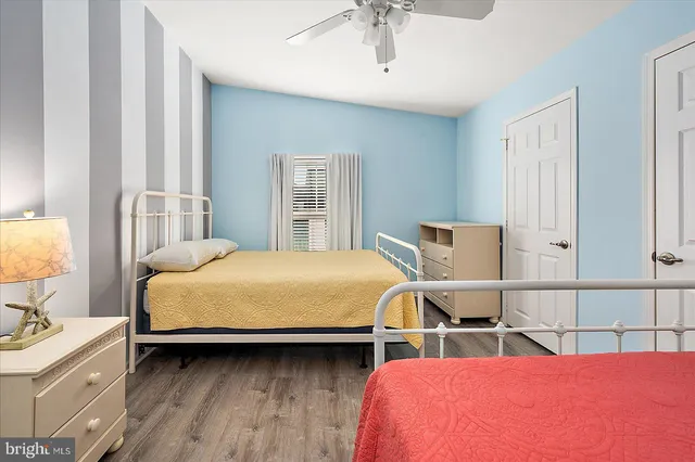 a bathroom with a granite countertop sink mirror vanity and toilet