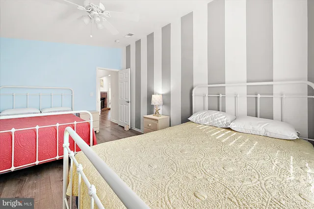 a bedroom with a large bed and a chandelier