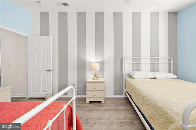 a bedroom with a bed and a ceiling fan