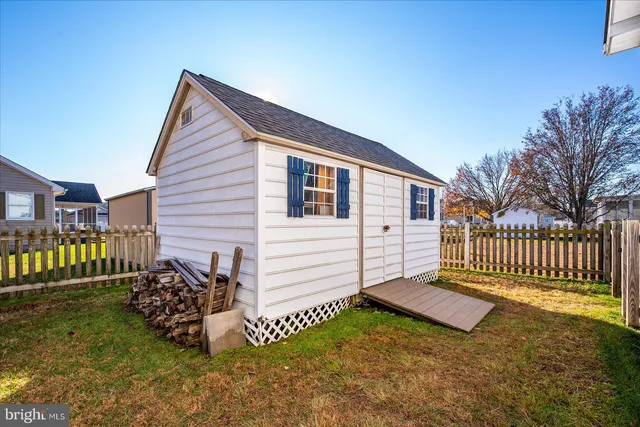 a view of a house with a yard patio and furniture