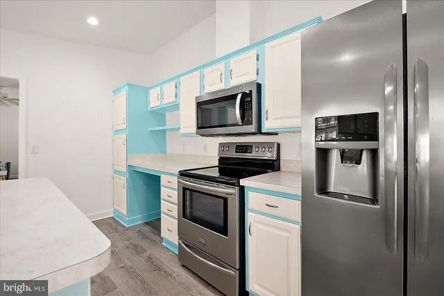 a kitchen with stainless steel appliances granite countertop a stove a refrigerator and a microwave