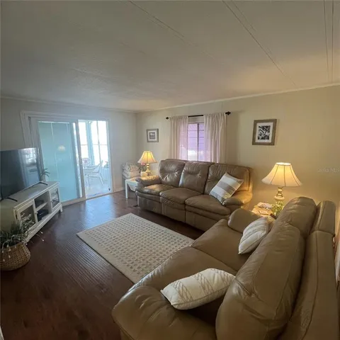 a living room with a couch and a table with wooden floor