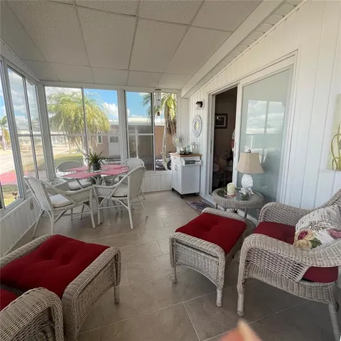 a living room with furniture and a floor to ceiling window