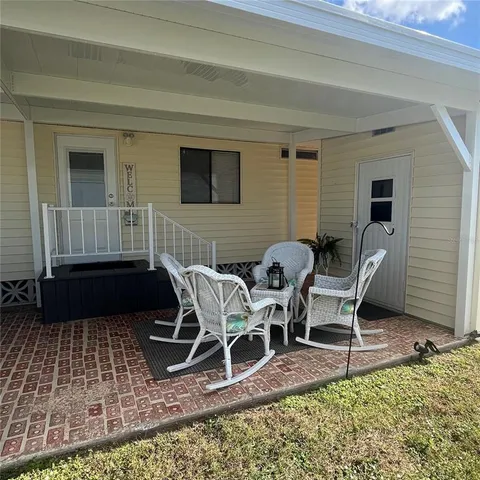a backyard of a house with table and chairs