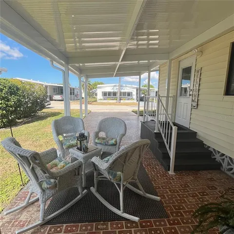 a view of a patio with couches chairs and potted plants