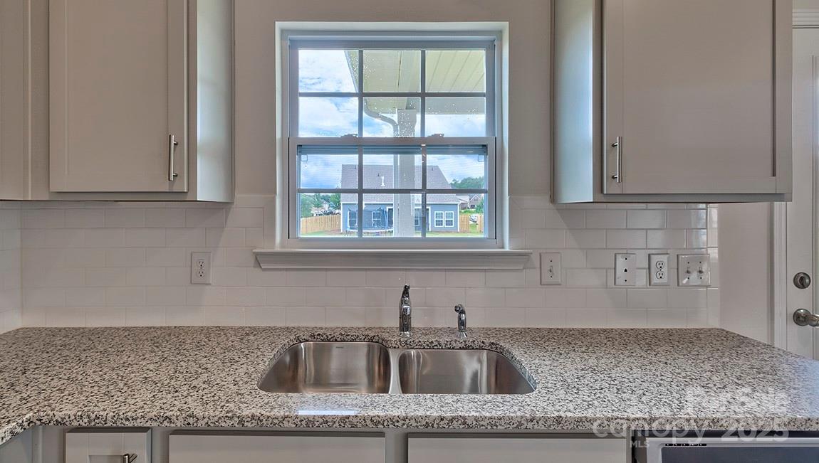 217 Shorthorn Road Fletcher, NC 28732 - Photo 4 of 19 a kitchen with granite countertop a sink window and cabinets