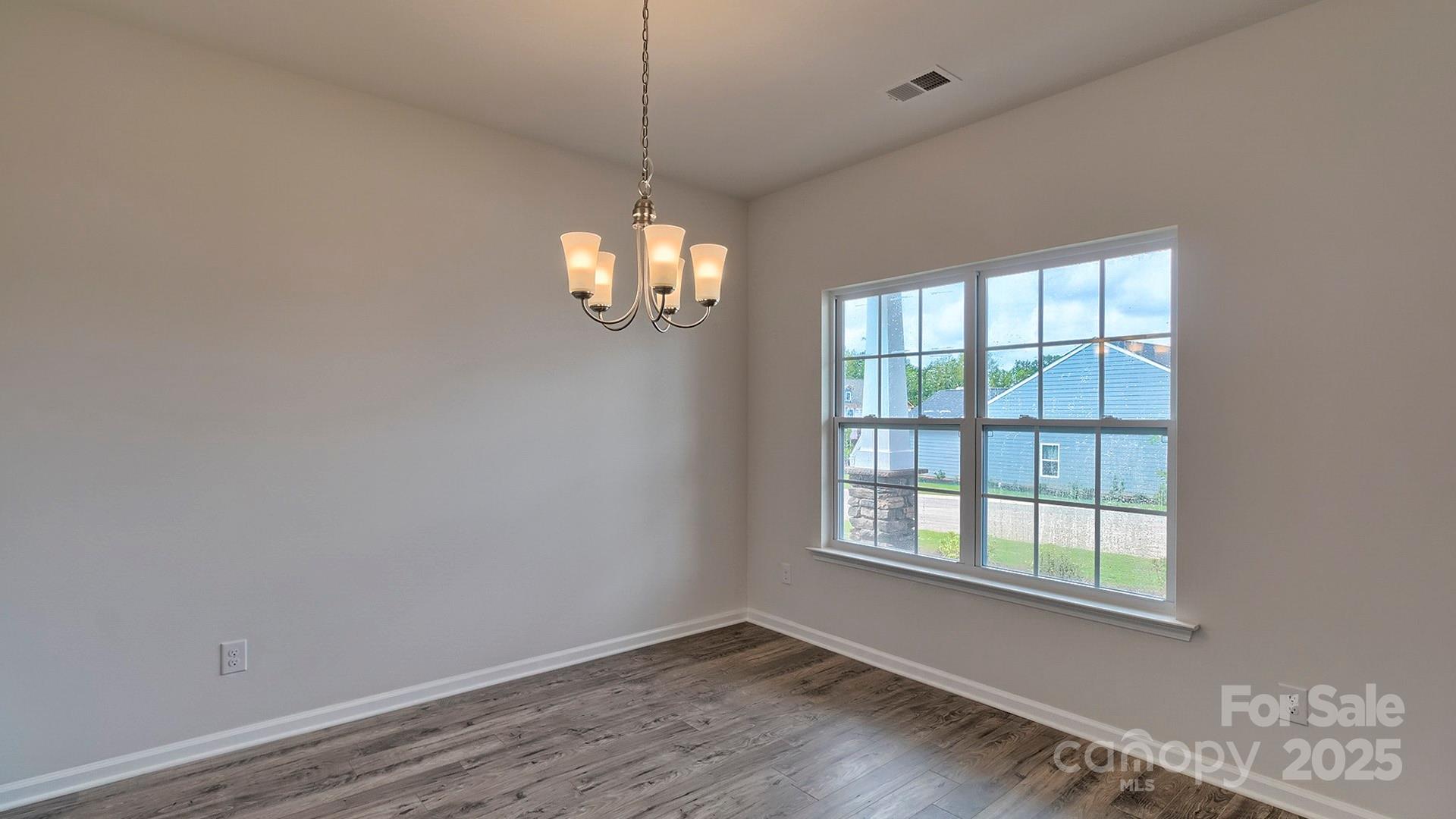 217 Shorthorn Road Fletcher, NC 28732 - Photo 9 of 19 a view of an empty room with wooden floor and a window