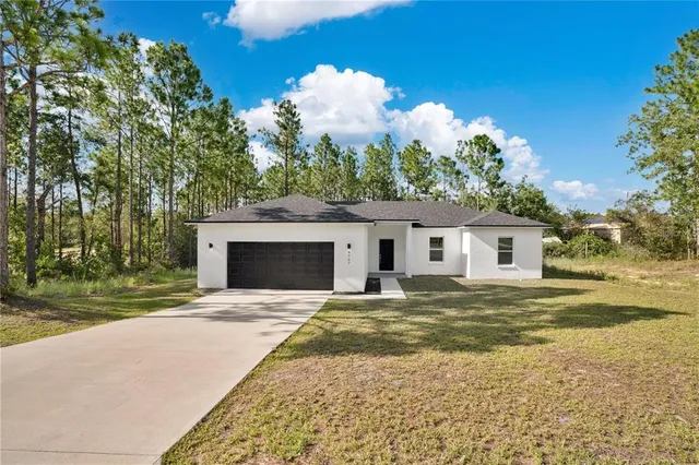 a view of a house with a yard and garage