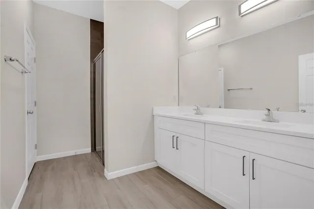 a bathroom with a double vanity sink and a mirror
