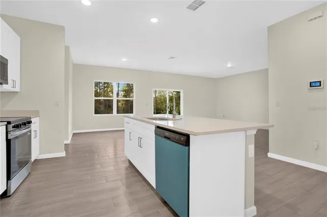 a kitchen with granite countertop a stove and a sink