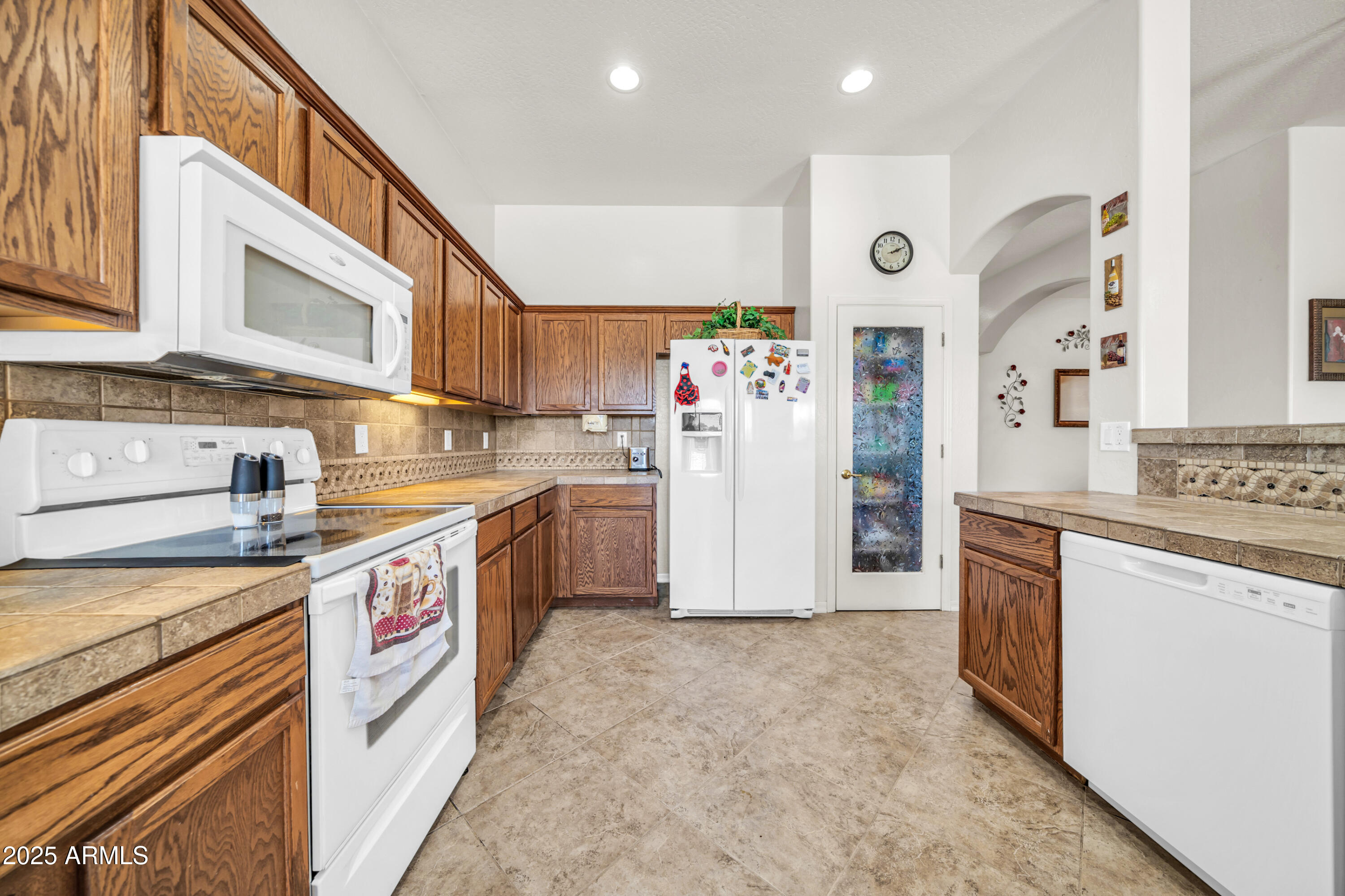 4314 West Summerside Road Laveen, AZ 85339 - Photo 11 of 26 a kitchen with stainless steel appliances granite countertop a stove a sink and a refrigerator