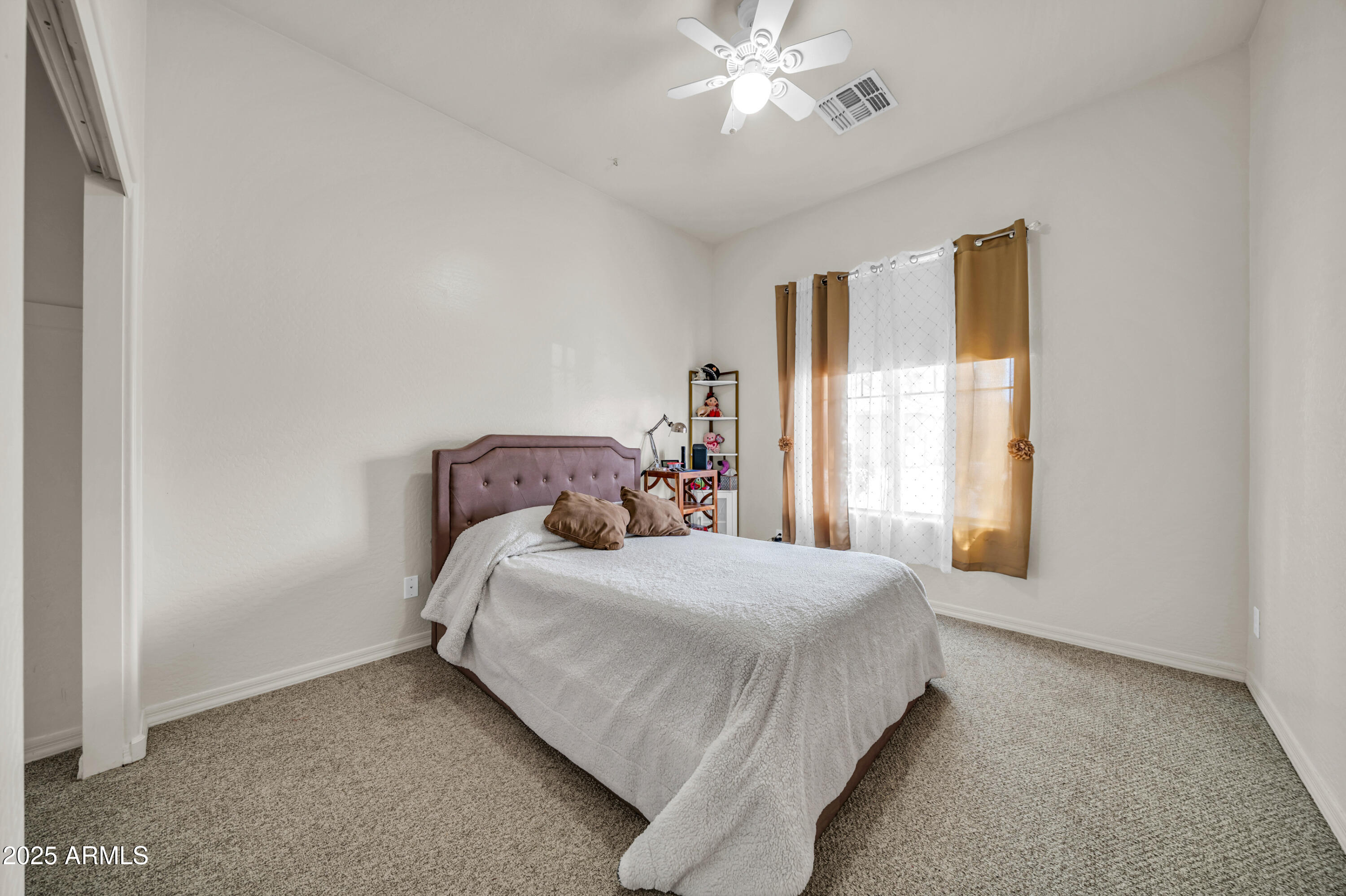 4314 West Summerside Road Laveen, AZ 85339 - Photo 18 of 26 a bedroom with a bed and a window