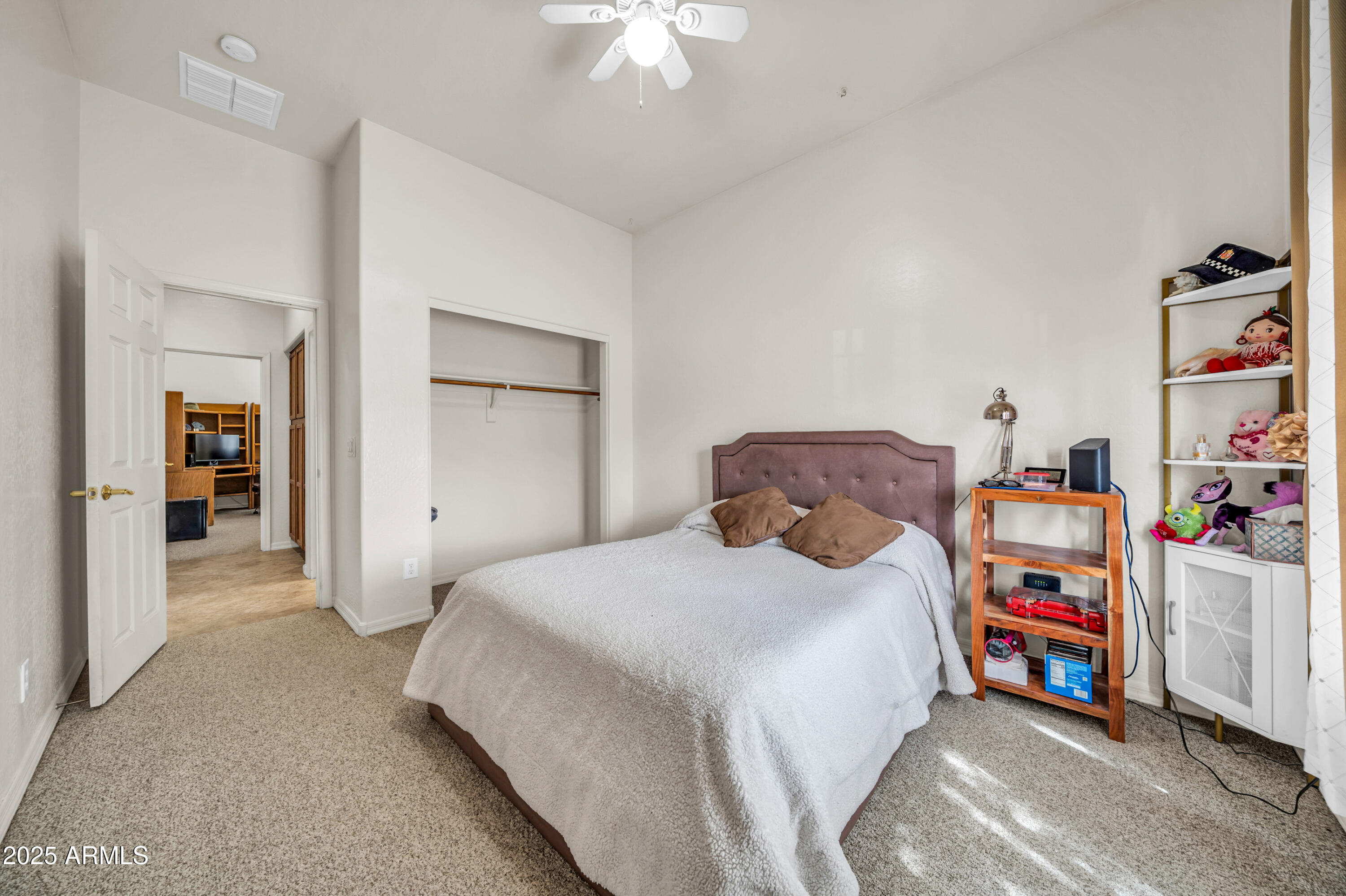 4314 West Summerside Road Laveen, AZ 85339 - Photo 19 of 26 a bedroom with a bed and a chandelier