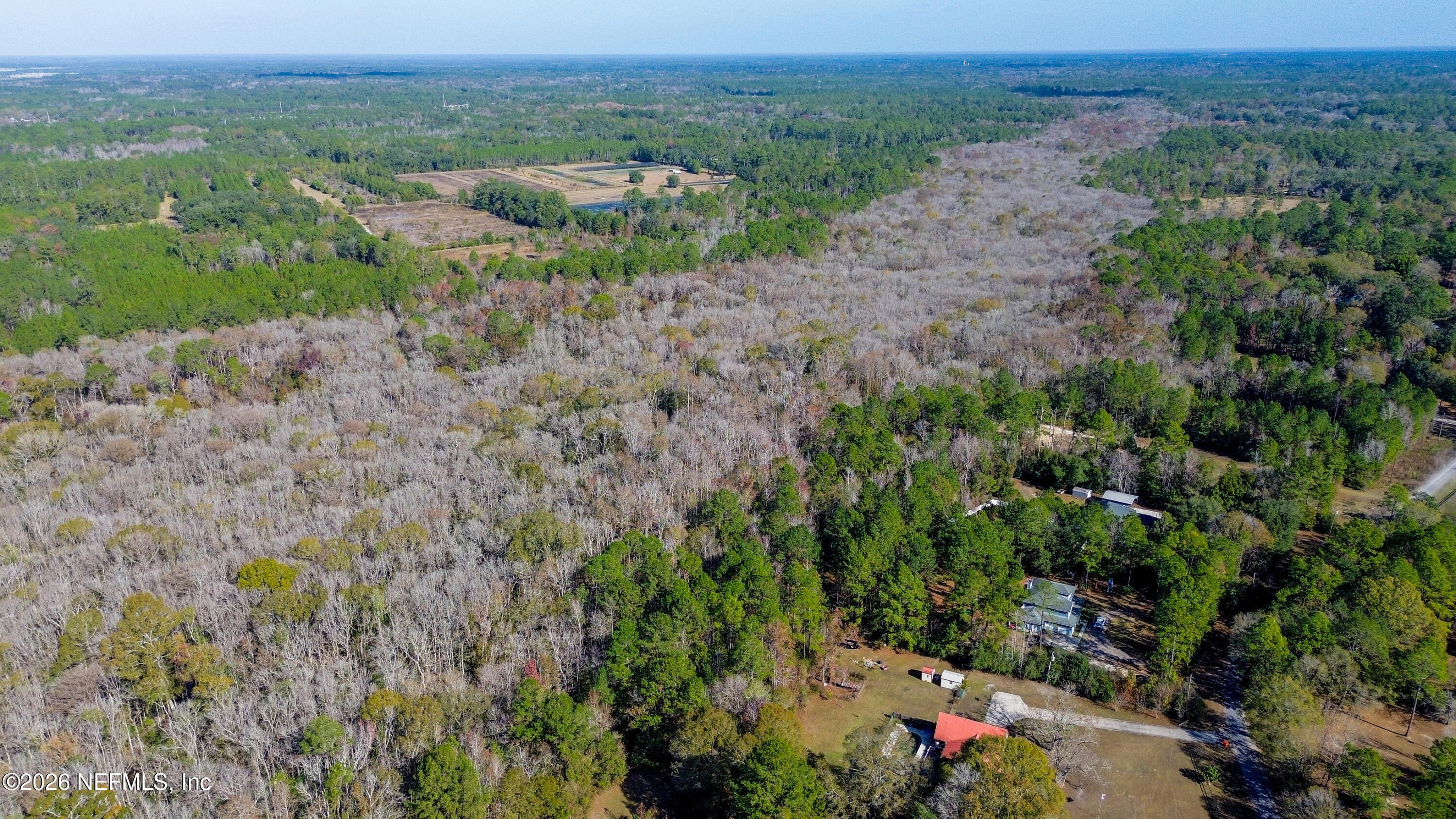 7847 Red Top Road Macclenny, FL 32063 - Photo 15 of 23 an aerial view of green landscape with trees houses and mountain view