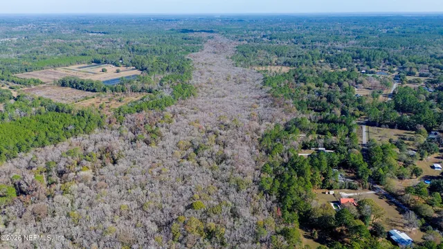an aerial view of a houses with a yard