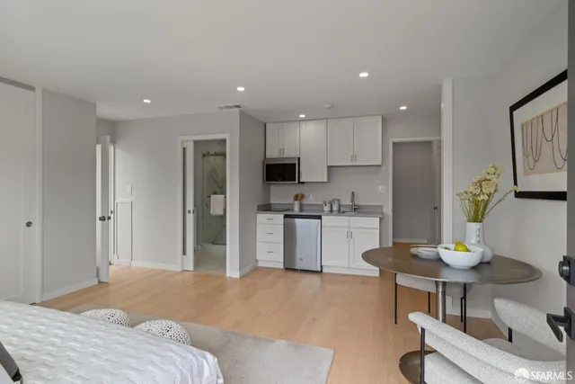a kitchen with a refrigerator and a stove top oven