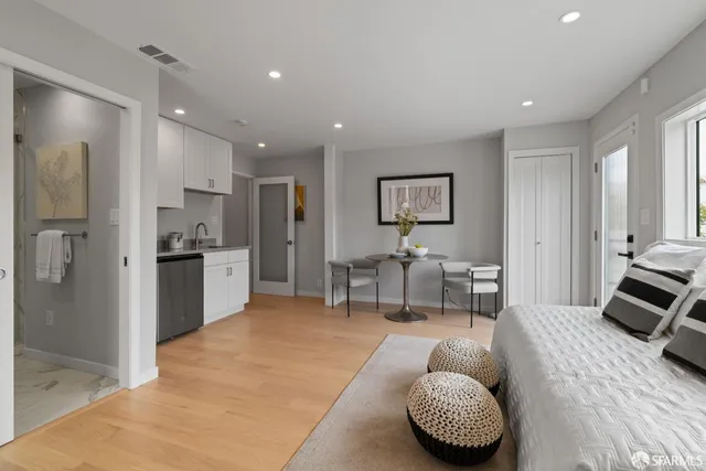 a living room with furniture and a view of kitchen