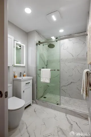 a bathroom with a toilet a sink and shower