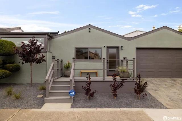 a view of a patio with table and chairs with wooden floor and fence