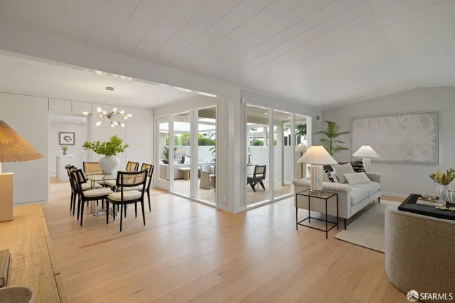a view of a livingroom with furniture dining room and wooden floor