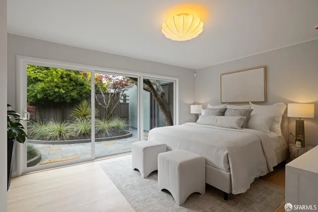 a bedroom with a bed and a large window