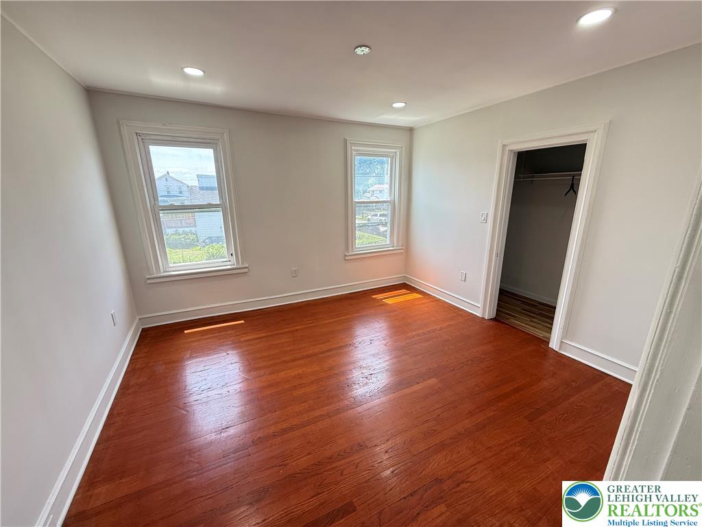 314 North Garfield Avenue Scranton, PA 18504 - Photo 14 of 21 Rich hardwood flooring complements clean white walls in this naturally illuminated bedroom.
