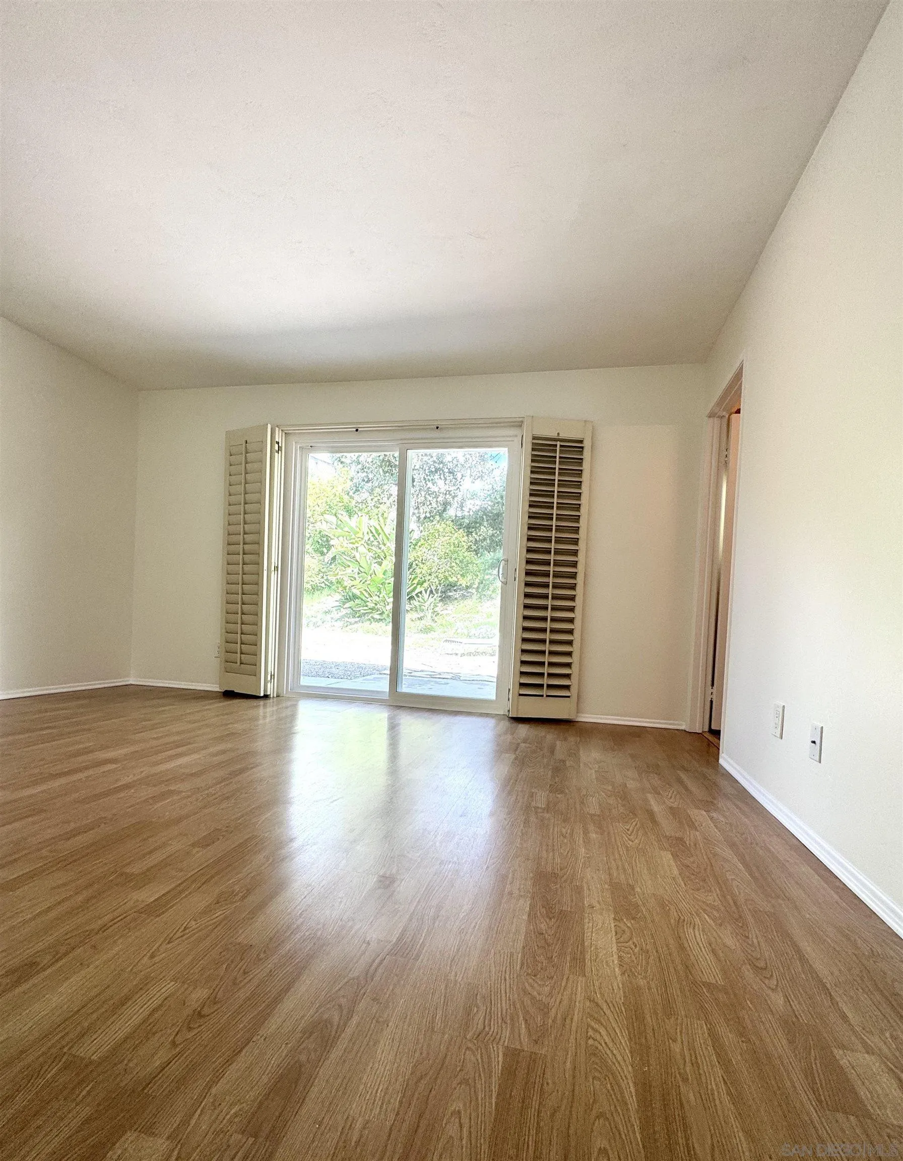 3754 Cameo Drive Oceanside, CA 92056 - Photo 11 of 31 an empty room with wooden floor and windows