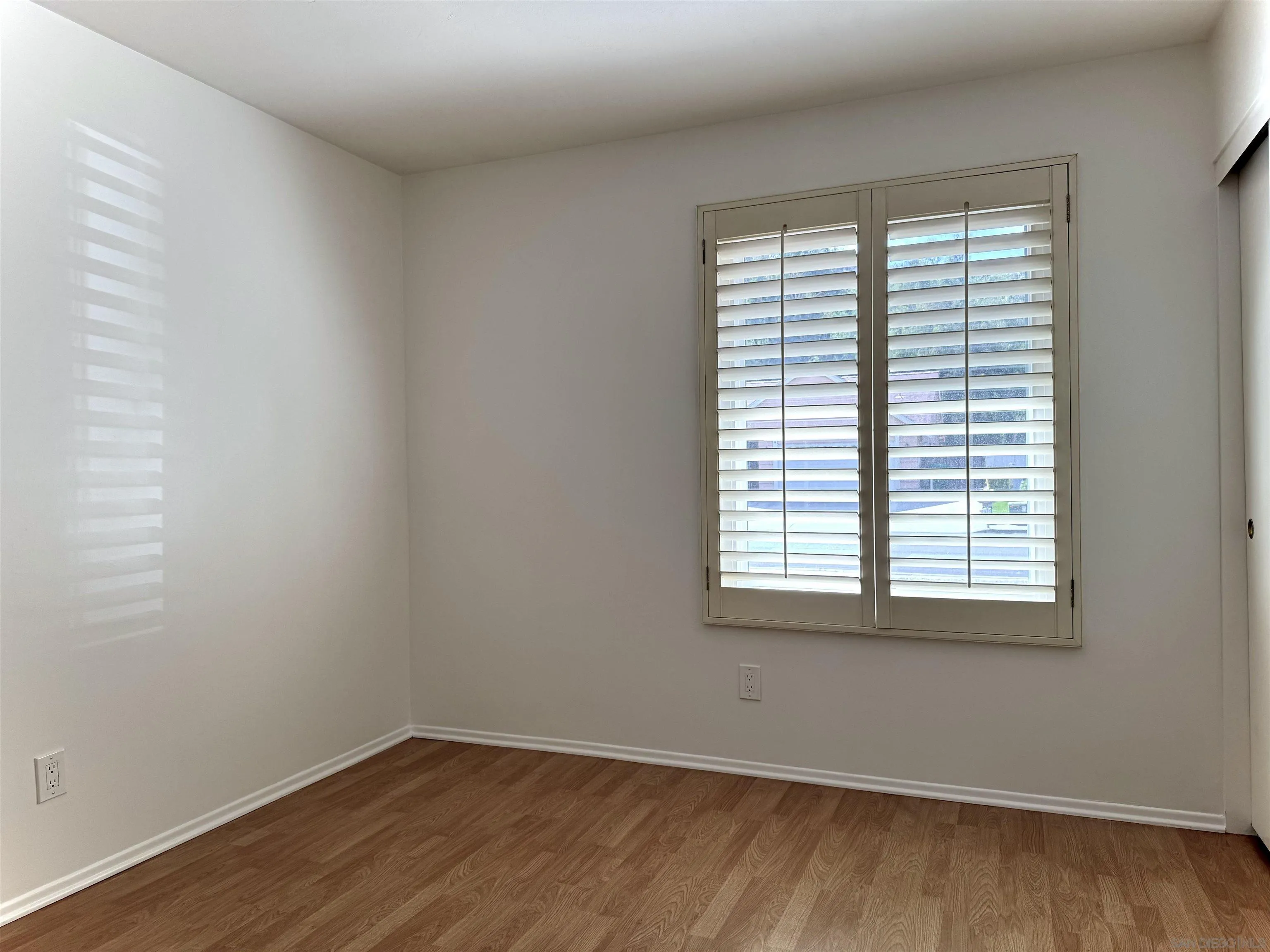3754 Cameo Drive Oceanside, CA 92056 - Photo 16 of 31 an empty room with wooden floor and a window