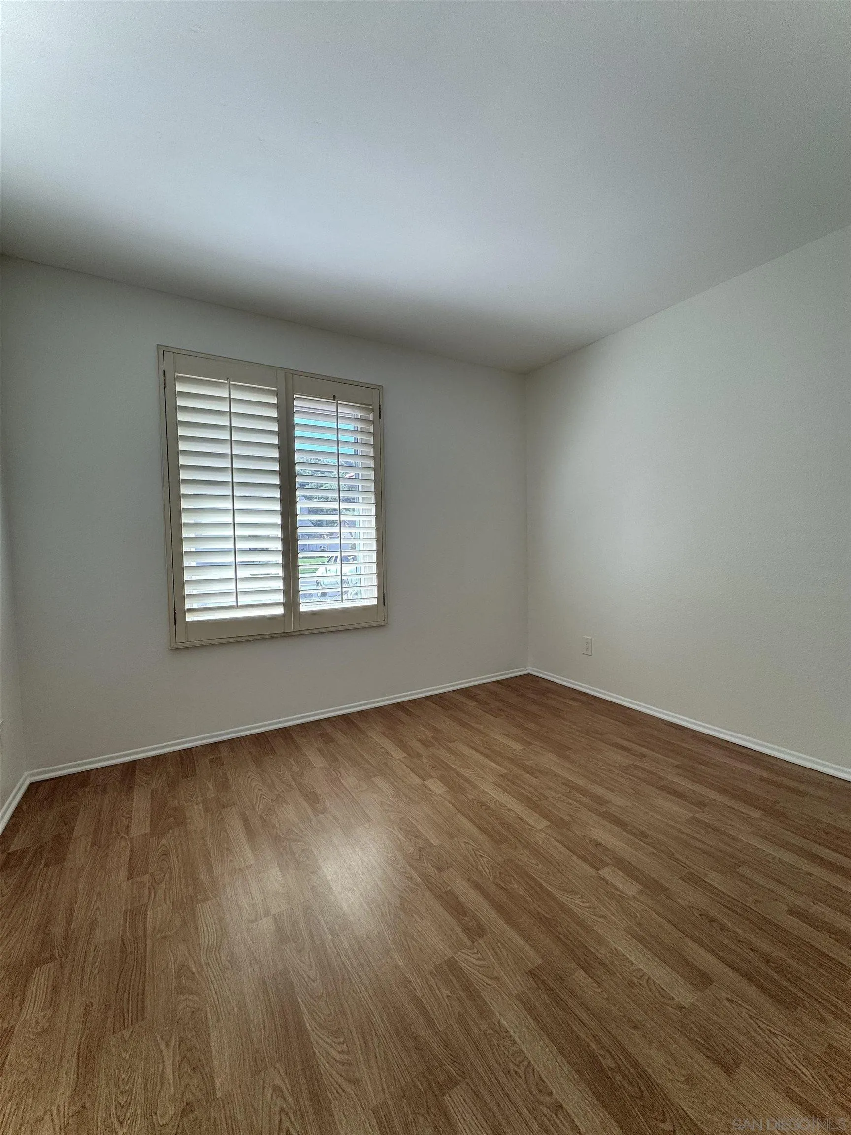 3754 Cameo Drive Oceanside, CA 92056 - Photo 17 of 31 an empty room with wooden floor and windows
