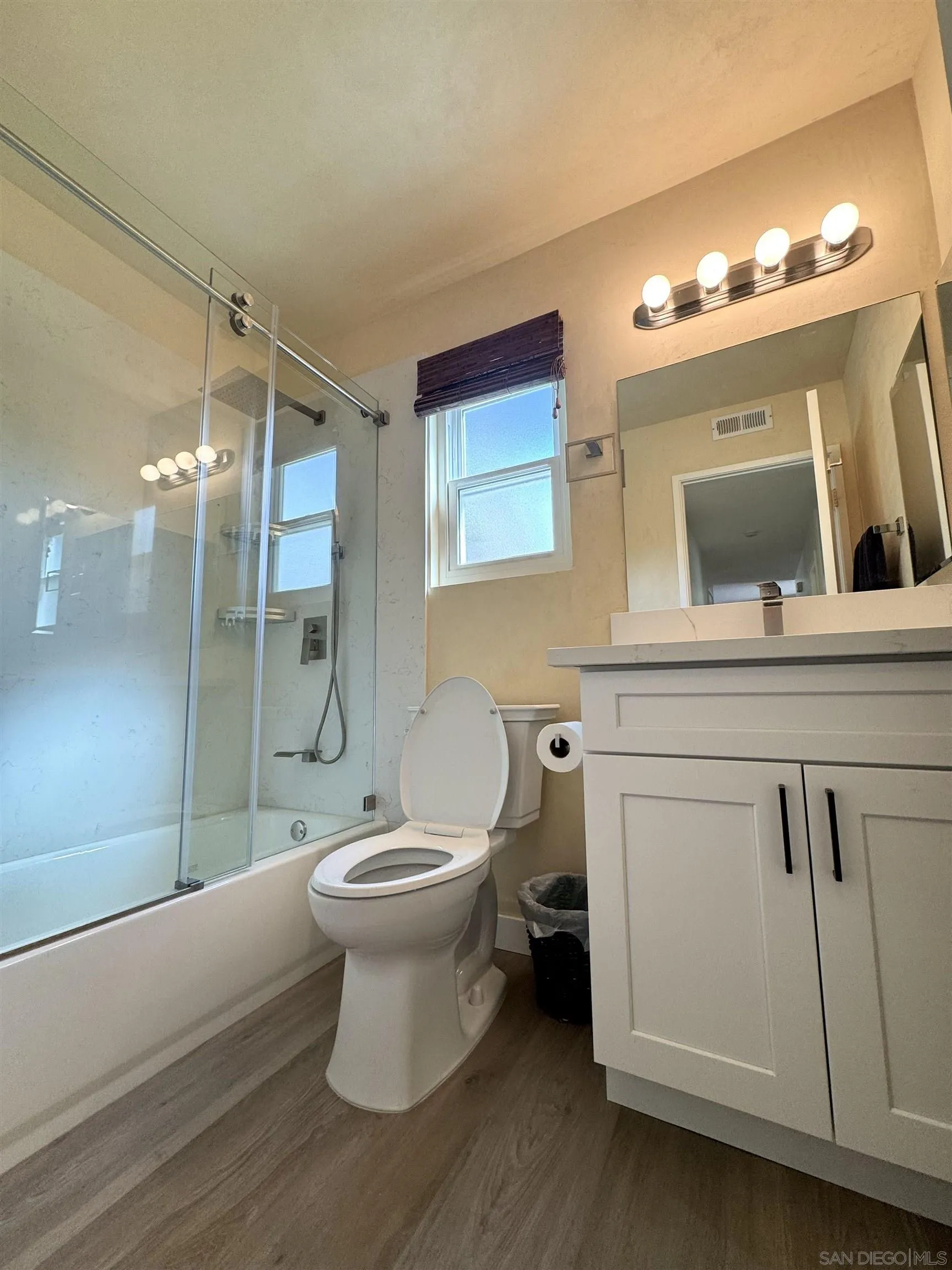 3754 Cameo Drive Oceanside, CA 92056 - Photo 19 of 31 a bathroom with a toilet sink and mirror
