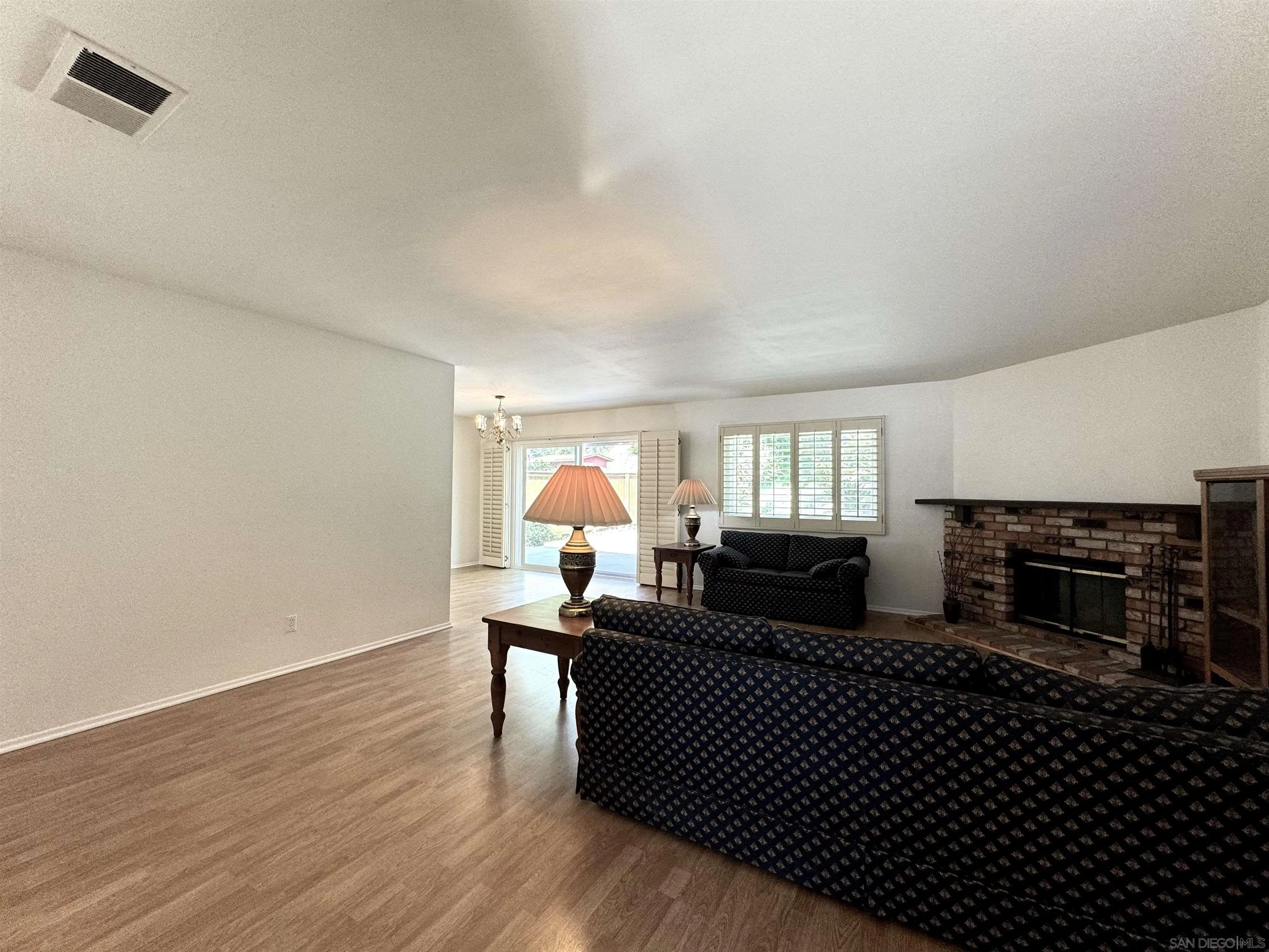 3754 Cameo Drive Oceanside, CA 92056 - Photo 3 of 31 a living room with furniture a fireplace and a flat screen tv