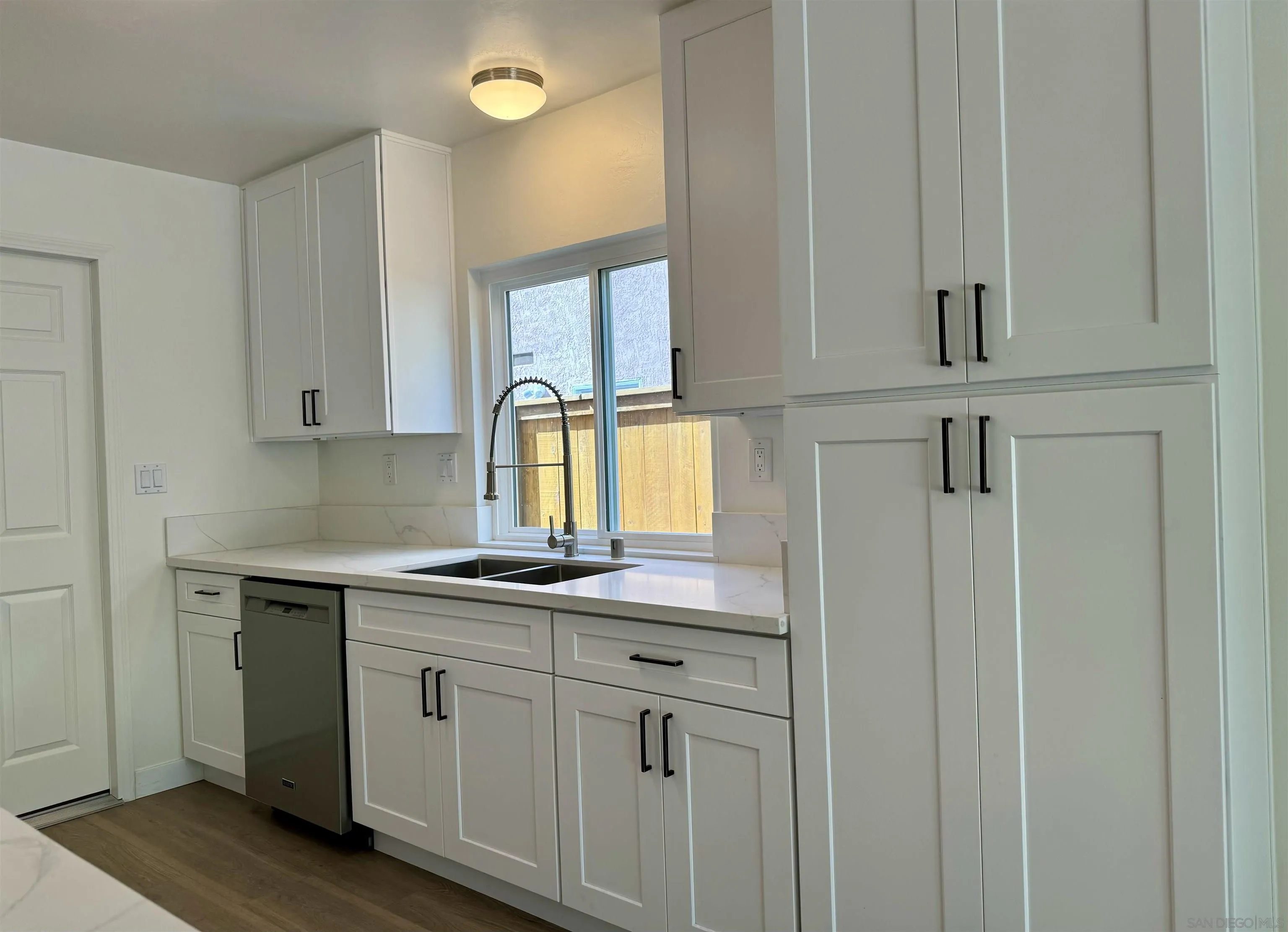 3754 Cameo Drive Oceanside, CA 92056 - Photo 8 of 31 a kitchen with white cabinets and a sink