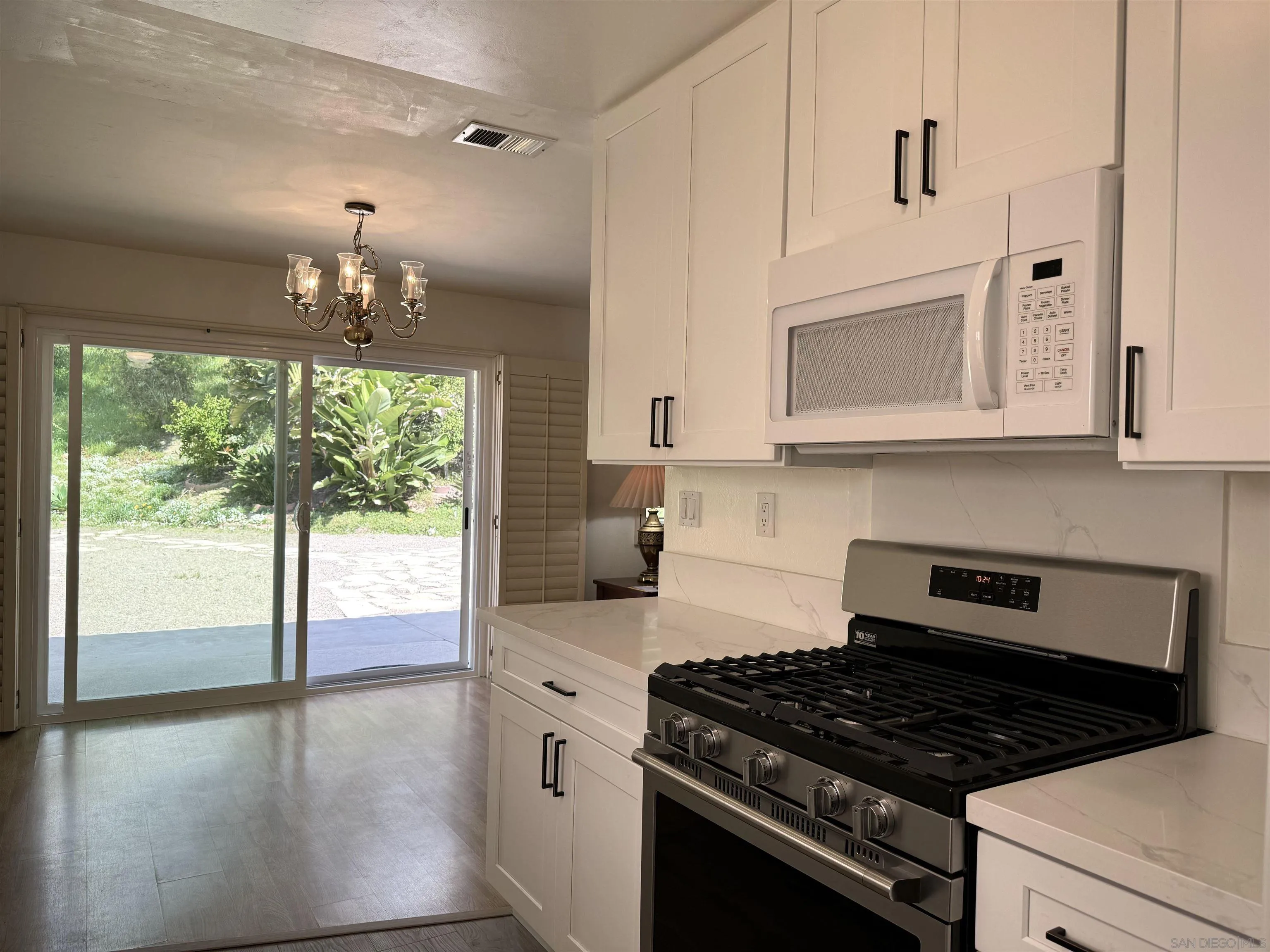 3754 Cameo Drive Oceanside, CA 92056 - Photo 9 of 31 a kitchen with stainless steel appliances granite countertop a stove and a microwave