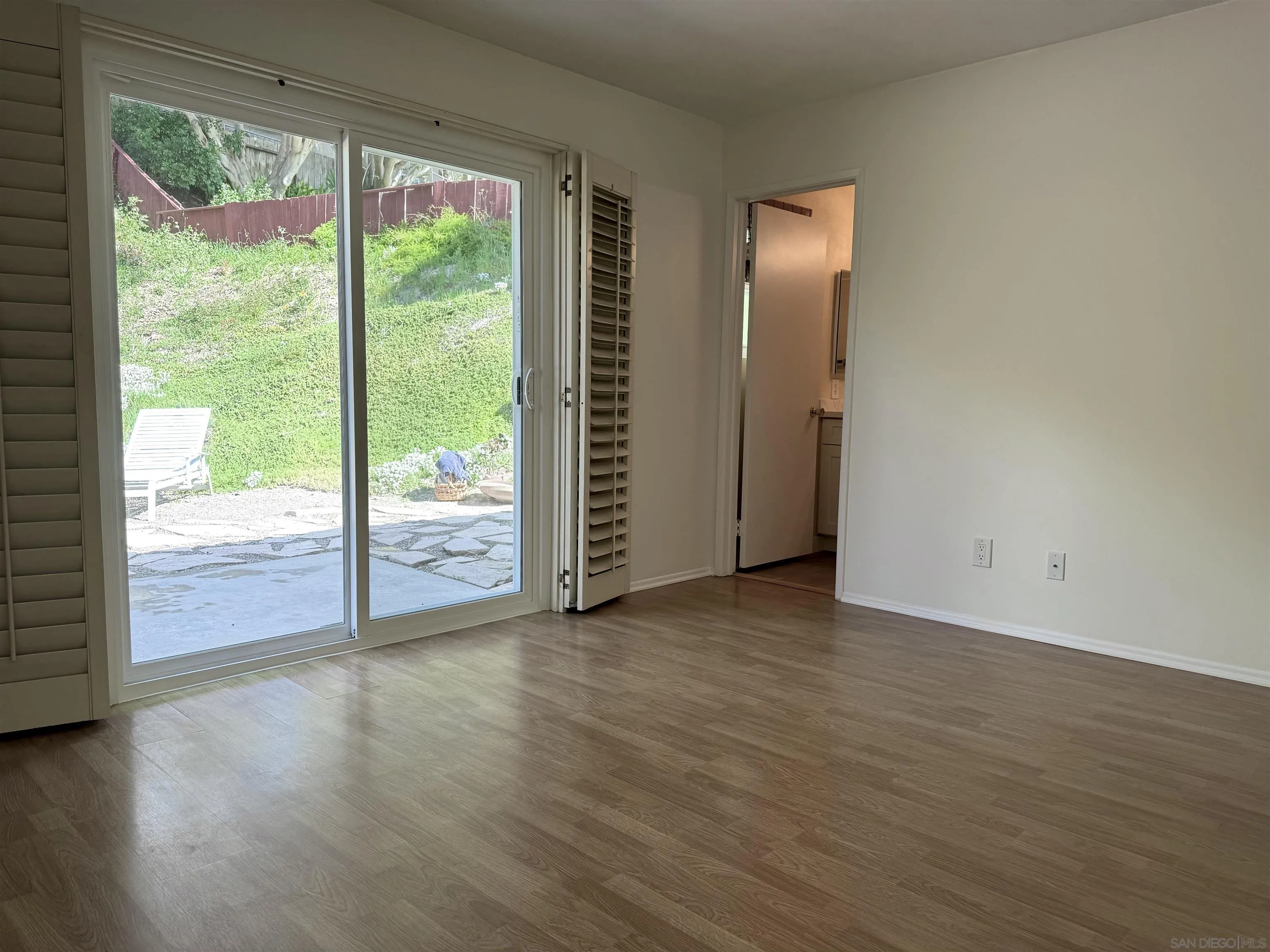 3754 Cameo Drive Oceanside, CA 92056 - Photo 10 of 31 an empty room with wooden floor and windows