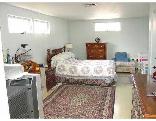 299 Beverly Road Brookline, MA 02467 - Photo 12 of 22 a bedroom with a bed and wooden floor