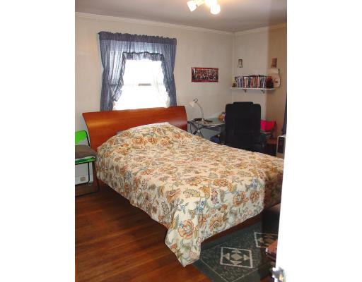 299 Beverly Road Brookline, MA 02467 - Photo 16 of 22 a bed sitting in a bedroom next to a window with kitchen view