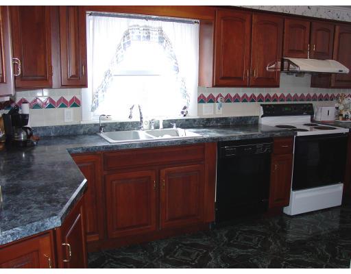 299 Beverly Road Brookline, MA 02467 - Photo 6 of 22 a kitchen with kitchen island granite countertop a sink window and cabinets