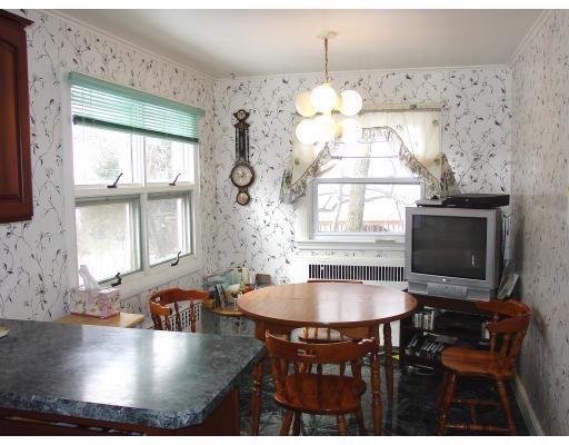 299 Beverly Road Brookline, MA 02467 - Photo 8 of 22 a kitchen with a dining table chairs and fireplace
