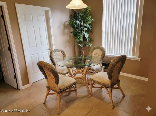 a dining room with furniture and window