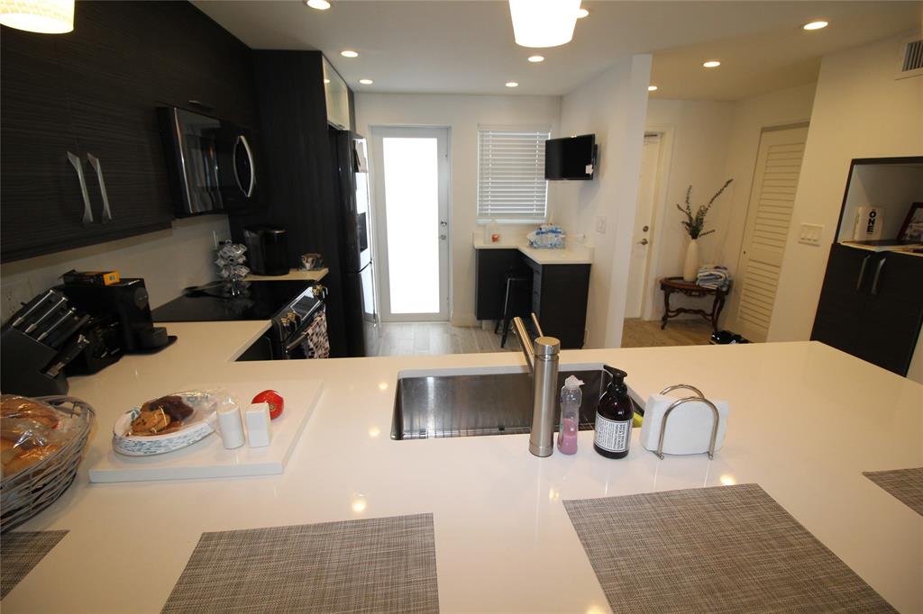 750 North Ocean Boulevard, Unit 1610 Pompano Beach, FL 33062 - Photo 11 of 17 a view of a kitchen with appliances and cabinets