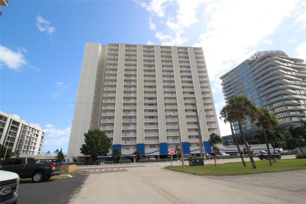 750 North Ocean Boulevard, Unit 1610 Pompano Beach, FL 33062 - Photo 16 of 17 a tall building sitting on the side of a street