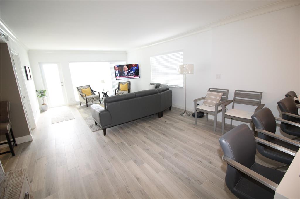 750 North Ocean Boulevard, Unit 1610 Pompano Beach, FL 33062 - Photo 4 of 17 a living room with furniture and a wooden floor