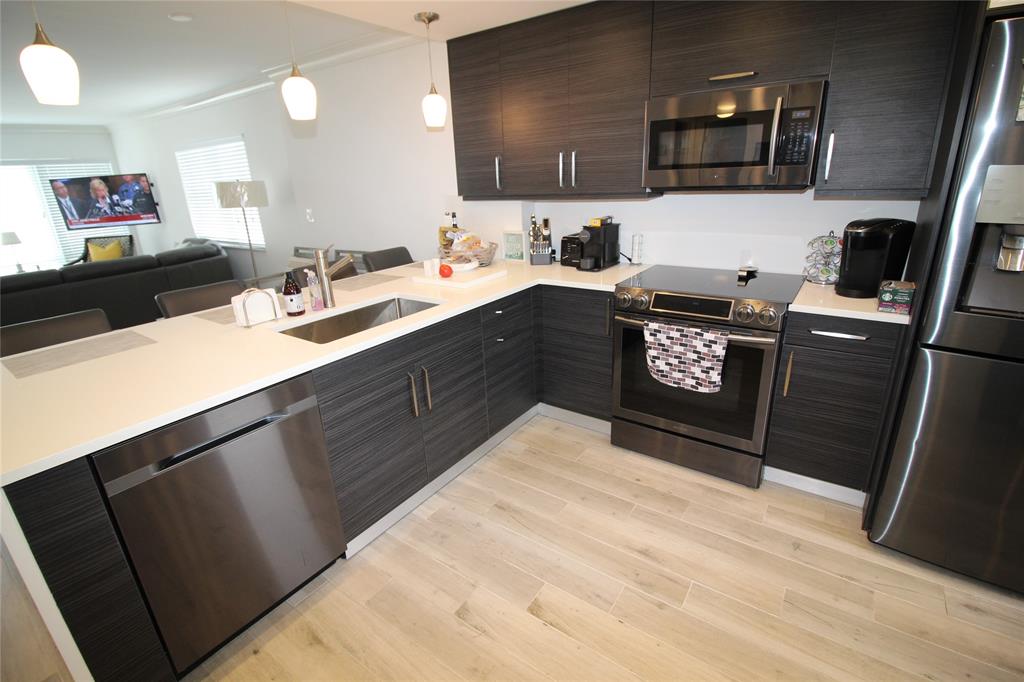 750 North Ocean Boulevard, Unit 1610 Pompano Beach, FL 33062 - Photo 5 of 17 a kitchen with a sink and a stove top oven